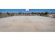 A basketball court area with benches on the side, and a playground in the background at 24199 W Hidalgo Ave, Buckeye, AZ 85326