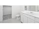 Modern bathroom with a clean design, white cabinetry, and minimalist fixtures at 24199 W Hidalgo Ave, Buckeye, AZ 85326