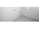 Empty laundry room with tile floors, a small window, and utility connections at 24199 W Hidalgo Ave, Buckeye, AZ 85326
