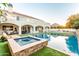 Expansive backyard features ample patio space, lush landscaping, and a sparkling pool and spa, perfect for entertaining guests at 2458 E Melrose St, Mesa, AZ 85213