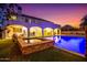 Backyard featuring a pool, spa, covered patio, and well-manicured lawn at 2458 E Melrose St, Mesa, AZ 85213