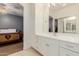 Bathroom with a bright vanity, mirror, and view to a bedroom creating a peaceful place to get ready at 2458 E Melrose St, Mesa, AZ 85213
