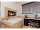 Bathroom featuring soaking tub, fireplace and vanity with seating at 2458 E Melrose St, Mesa, AZ 85213