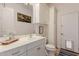 Bright bathroom features white cabinets, decorative mermaid art, and convenient pet door at 2458 E Melrose St, Mesa, AZ 85213
