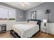 Cozy bedroom with gray walls, a ceiling fan, a comfortable bed, and a view of the outside at 2458 E Melrose St, Mesa, AZ 85213