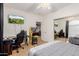 Bright bedroom with a bed, TV, arcade game and mirrored closet at 2458 E Melrose St, Mesa, AZ 85213