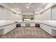Large craft room with custom cabinets, built-in desks, and large window at 2458 E Melrose St, Mesa, AZ 85213
