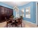 Charming dining room with light blue walls, wood table, and natural light from the windows at 2458 E Melrose St, Mesa, AZ 85213