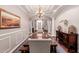 Elegant dining room featuring tray ceilings, detailed molding, and a statement chandelier at 2458 E Melrose St, Mesa, AZ 85213