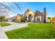 Brick home showing arched entrance, manicured lawn, and circular driveway at 2458 E Melrose St, Mesa, AZ 85213