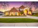 Brick home featuring arched entrance, manicured lawn, and circular driveway at 2458 E Melrose St, Mesa, AZ 85213