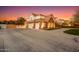 Three-car garage with a spacious driveway and beautifully landscaped grounds at 2458 E Melrose St, Mesa, AZ 85213