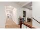 Hallway with neutral carpet, archways, and a view into the bathroom at 2458 E Melrose St, Mesa, AZ 85213