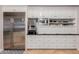 Custom kitchen with stainless steel refrigerator, built-in microwave, and lots of storage space at 2458 E Melrose St, Mesa, AZ 85213