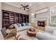 Inviting living room with a fireplace, built-in bookcase, and neutral tones creating a warm atmosphere at 2458 E Melrose St, Mesa, AZ 85213