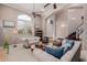 Spacious living room featuring an arched window, and a staircase leading to the upper level at 2458 E Melrose St, Mesa, AZ 85213