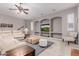 Spacious living room with ceiling fan, recessed lighting, and built-in shelving at 2458 E Melrose St, Mesa, AZ 85213