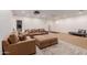 Open-concept living area with a large sofa, ottoman, and stylish rug, perfect for relaxation at 2458 E Melrose St, Mesa, AZ 85213