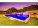 A luxurious pool featuring stone accents and multiple waterfalls is perfect for recreation and relaxation in a serene backyard at 2458 E Melrose St, Mesa, AZ 85213