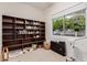 Bright room with large window, large bookcase filled with various books and decor at 2458 E Melrose St, Mesa, AZ 85213