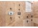 Detailed tile shower featuring multiple shower heads and controls, with natural light from a window at 2458 E Melrose St, Mesa, AZ 85213