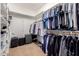 Carpeted walk-in closet with rods, shelving, and overhead storage perfect for organization at 2458 E Melrose St, Mesa, AZ 85213