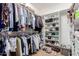 Spacious walk-in closet featuring ample hanging space, built-in shelving for shoes, and organizational potential at 2458 E Melrose St, Mesa, AZ 85213