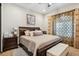 Bedroom with a ceiling fan, upholstered bed and bench, and decorative pillows and curtains at 26019 W Ponderosa Ln, Buckeye, AZ 85396