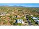 Attractive aerial view of a home in a desert community on a sunny day with rolling hills in the distance at 27467 N 75Th Way, Scottsdale, AZ 85266