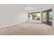 Light-filled bedroom with carpeted floors and sliding glass doors to the outside at 27467 N 75Th Way, Scottsdale, AZ 85266