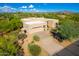 Desert home showcasing a native landscaped yard with a private driveway and a two-car garage at 27467 N 75Th Way, Scottsdale, AZ 85266