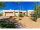 Front elevation of a modern desert home with drought-tolerant landscaping including cacti and succulents at 27467 N 75Th Way, Scottsdale, AZ 85266