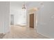 Bright foyer boasts tile floors, a wooden front door, high ceilings and modern light fixtures at 27467 N 75Th Way, Scottsdale, AZ 85266