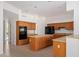 Spacious kitchen with wooden cabinets, island, and black appliances at 27467 N 75Th Way, Scottsdale, AZ 85266
