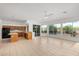 Bright living room area with tile flooring, kitchen, and large windows overlooking the outdoor space at 27467 N 75Th Way, Scottsdale, AZ 85266