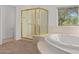 Bright main bathroom featuring a corner shower with gold trim and a soaking tub at 27467 N 75Th Way, Scottsdale, AZ 85266