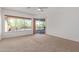 Bright main bedroom with carpet, a ceiling fan, and sliding glass doors with a pool view at 27467 N 75Th Way, Scottsdale, AZ 85266