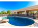 Inviting pool with rock features surrounded by a patio and lush desert landscape at 27467 N 75Th Way, Scottsdale, AZ 85266