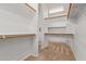 Spacious walk-in closet featuring carpeting, shelving, and wooden hanging rods at 27467 N 75Th Way, Scottsdale, AZ 85266