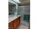 Bathroom with a vanity, large mirror, and glass-enclosed shower stall at 276 Leisure World --, Mesa, AZ 85206