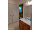 Bathroom with a wooden vanity, tiled floor, and a view into an adjacent room at 276 Leisure World --, Mesa, AZ 85206