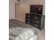 Bedroom with a large dresser and television, and a patterned bedspread at 276 Leisure World --, Mesa, AZ 85206