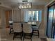 Dining area features modern chandelier, dining table and direct access to backyard at 276 Leisure World --, Mesa, AZ 85206