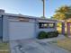 View of the home's exterior with well maintained landscaping, driveway, and desert themed art at 276 Leisure World --, Mesa, AZ 85206