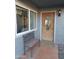 Inviting front door with decorative glass, adjacent bench, and covered porch area at 276 Leisure World --, Mesa, AZ 85206