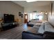 Inviting living room featuring a large sectional sofa, wood floors, and entertainment center at 276 Leisure World --, Mesa, AZ 85206