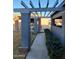 Covered walkway features modern supports, mature shrubs, and access to the front entrance at 276 Leisure World --, Mesa, AZ 85206