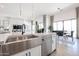 Open concept living with kitchen island, dining, and living area with fireplace at 28265 N 158Th St, Scottsdale, AZ 85262