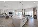 Open floor plan boasts a kitchen island, sleek pendant lighting, and seamless flow to the dining and living spaces at 28265 N 158Th St, Scottsdale, AZ 85262