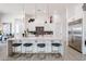 Bright kitchen with oversized island, seating for four, and stainless steel refrigerator at 28265 N 158Th St, Scottsdale, AZ 85262